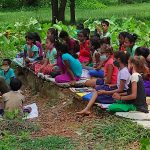 Village-teacher-teaching-group-of-students-in-field-(tbjf.org)