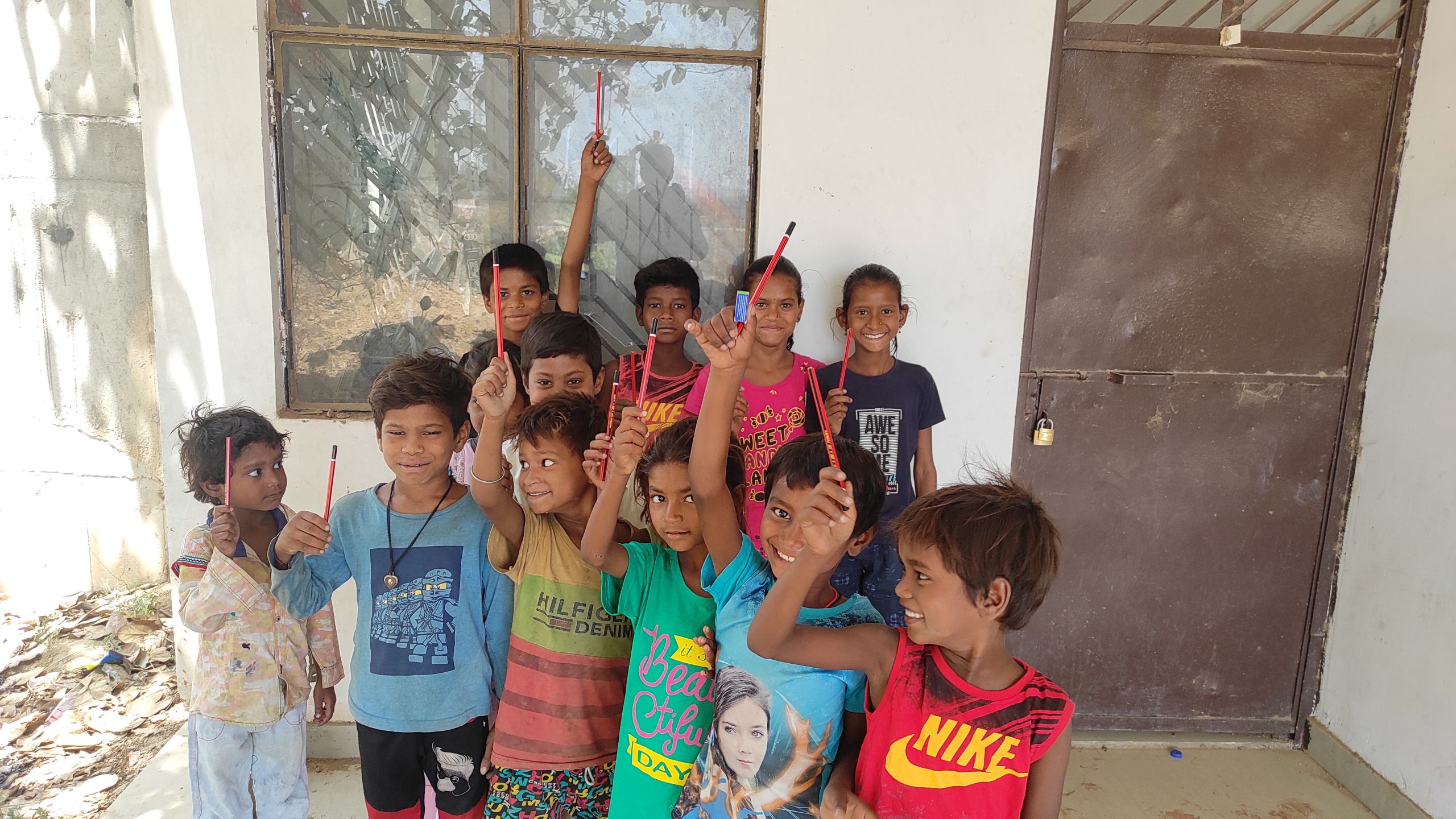 Village children getting free Education pencils in their hand